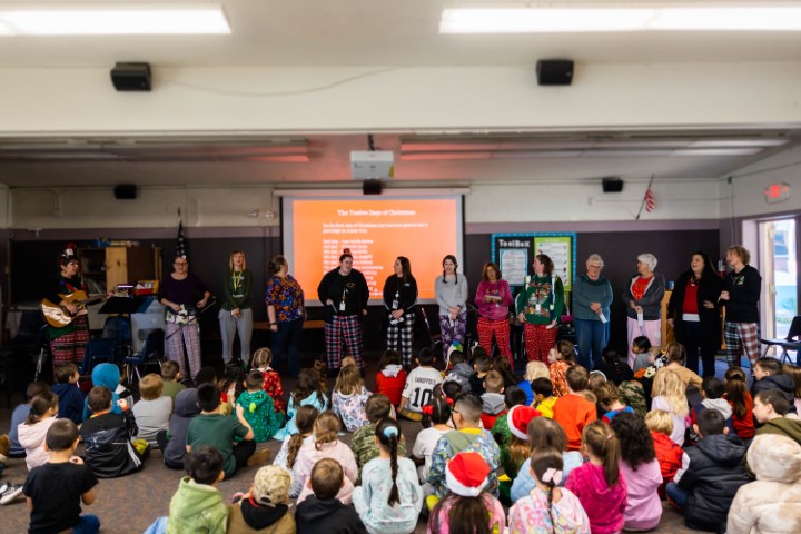 Teachers, staff, students, and families gathered singing Christmas songs.